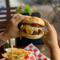 Normans GAUCHO Burger · Grass fed burger with caramelized onion, cheddar-jack, topped with chorizo and fried egg.