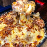 Half Baked Mac & Cheese · Famous creamy mac and cheese, oven baked in a cast iron skillet topped with grass fed beef c...