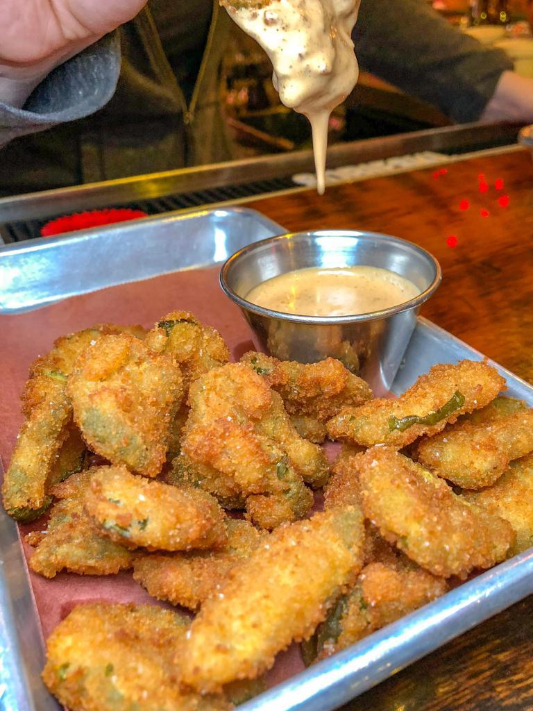Fried Pickles · Sliced dill pickles fried in a lager beer batter and served with spicy BBQ aioli.