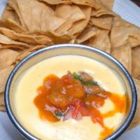 Chef's Queso · Fresh made spicy cheese sauce and fresh cut pico de gallo and served with house made corn to...
