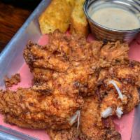 Buttermilk Chicken Tenders · Buttermilk brined chicken tenders served with habanero ranch dressing, honey mustard and cor...