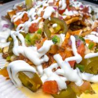 Chili Cheese Nachos · Chili, 3 cheese sauce, pico de gallo, sour cream and jalapenos served over house made corn t...