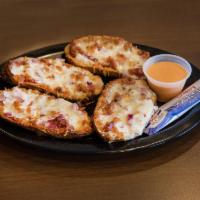 Stuffed Potato Skins · Potato halves stuffed with cheddar jack cheese, onions, bacon, sour cream and awesome sauce.