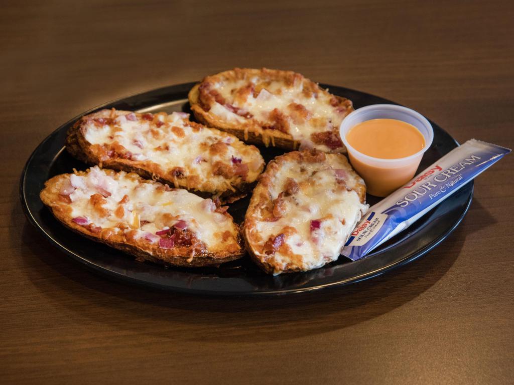Stuffed Potato Skins · Potato halves stuffed with cheddar jack cheese, onions, bacon, sour cream and awesome sauce.