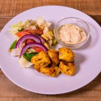 Chicken Kebab · Boneless chicken marinated with herbs and spices. Served with salad, hummus and pita bread.