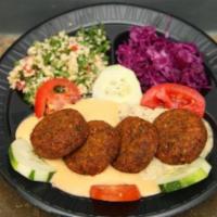 37. Falafel Platter · A serving of baba ganouj, hummus, tabouli, pickled red cabbage and falafel served with tahin...