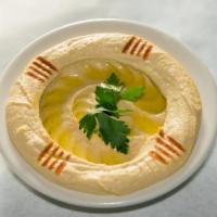 Hummus · Mashed chickpeas blended with tahini paste, a touch of garlic, lemon juice and olive oil. 