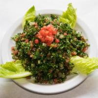 Tabouleh Salad · Finely chopped Italian parsley, tomatoes, onions and burgul all tossed in lemon juice and ol...