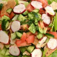 Fattoush Salad · Romaine lettuce, tomatoes, onions, radishes, cucumbers and parsley tossed in our fattoush dr...