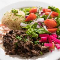 Beef Shawarma · Slices of marinated beef slowly cooked on an upright spit. Served with gaby's house salad an...