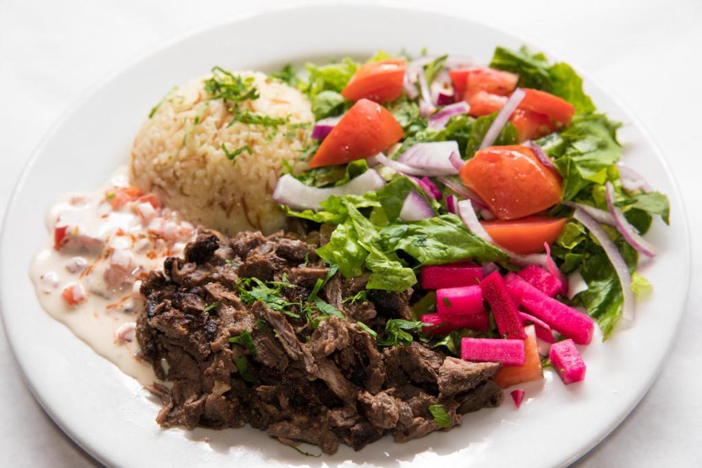 Beef Shawarma · Slices of marinated beef slowly cooked on an upright spit. Served with gaby's house salad and rice. 