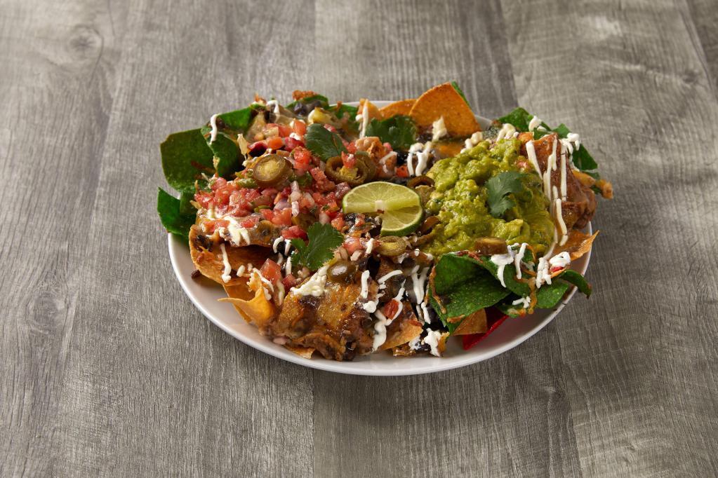 Fiesta Nachos · Chips with cheese and a variety of toppings. Add meat for an additional charge.