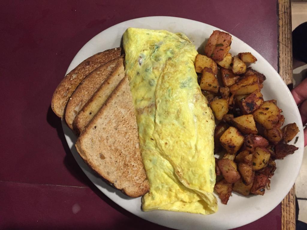 Western Omelette · Green peppers, onions and ham. Prepared with 3 large eggs and served with home fries and choice of toast.