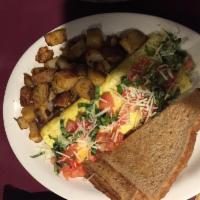 Eau Claire Omelette · Cheddar and Brie cheeses topped with tomato, basil and shredded Parmesan cheese. Prepared wi...