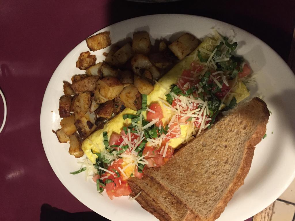 Eau Claire Omelette · Cheddar and Brie cheeses topped with tomato, basil and shredded Parmesan cheese. Prepared with 3 large eggs and served with home fries and choice of toast.