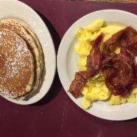 2 X 4 · 2 pancakes, 2 eggs any style, 2 sausages and 2 pieces of bacon.