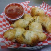 Garlic Knots Basket (8 pc) · 8 hand made bread knots using our signature pizza dough and a blend of spices. Served with a...