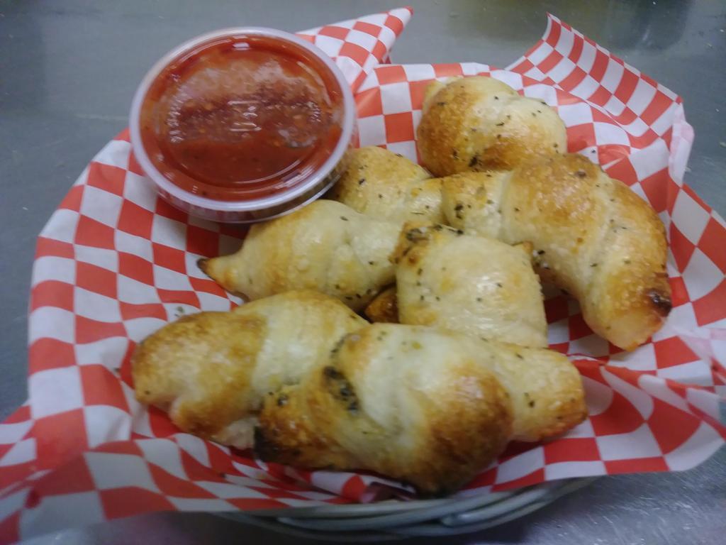 Garlic Knots Basket (8 pc) · 8 hand made bread knots using our signature pizza dough and a blend of spices. Served with a marinara sauce. * Local favorite *.