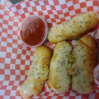 Pepperoni Rolls (4 rolls) · 4 handmade pepperoni and mozzarella stuffed rolls using our signature pizza dough. Comes wit...