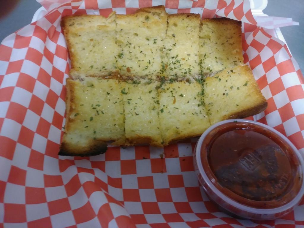 Garlic Bread (8 pc) · 8 pieces of our sub sandwich bread covered with our garlic butter blend and served with a marinara sauce.