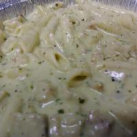 Creamy Chicken Pesto Pasta · Penne pasta with chicken in an Alfredo and pesto blend. Pasta comes with side salad and garl...