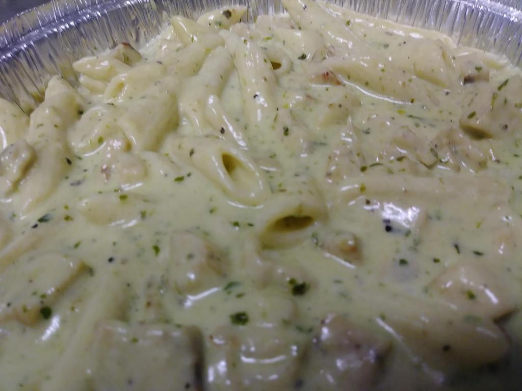 Creamy Chicken Pesto Pasta · Penne pasta with chicken in an Alfredo and pesto blend. Pasta comes with side salad and garlic Knots