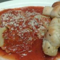 Meat Ravioli · Stuffed pasta with meat, covered with homemade tomato sauce and cheeses and baked to perfect...
