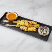 Chicken Satay · Marinated chicken served on skewers with homemade peanut sauce and cucumber sauce.