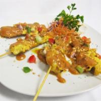 Chicken Satay (4 pcs) · Grilled marinated chicken served with cucumber and peanut sauce.