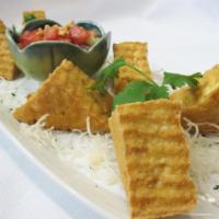 Golden Tofu (8 pcs) · Fried tofu served with crushed peanuts over sweet and sour sauce. Vegetarian.