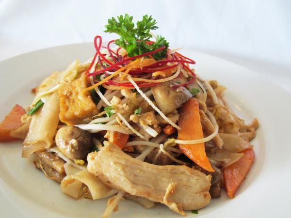 Messy Noodles · Stir-fried flat noodles, tofu, eggs, mushrooms, carrots, scallions, bean sprouts in brown sesame oil sauce. Vegetarian.