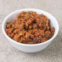 Ezme · Finely chopped tomato, onion, parsley mixed with seedless chili flakes and olive oil.
