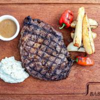 Rib Eye Steak · 12 oz rib eye steak cooked to your taste and served with grill potato, pistachio mixed smoke...