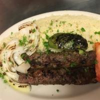 Kafta Kabob Entree · Grilled seasoned ground cuts of tender beef, minced onion, and parsley served with rice, sal...