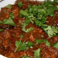 Mutton Mandhakini · Semi gravy goat cooked with onions, chilies and chopped boiled egg.