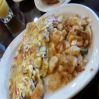 Hungry Man Omelette · 4 eggs, peppers, onions, tomatoes, bacon, ham, sausage and American cheese. Served with pota...