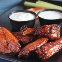 Smoked Chicken Wings · Smoked and Flash Fried Wings Tossed in your Choice of Tangy BBQ, Dry Lemon Pepper Rub or Buf...