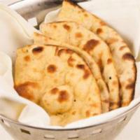 Tandoori Roti · Round whole wheat baked bread cooked in clay oven.