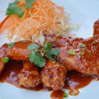 A7. Chicken Wing · 5 pieces. Marinated fried chicken wing with Thai sweet and sour sauce.
