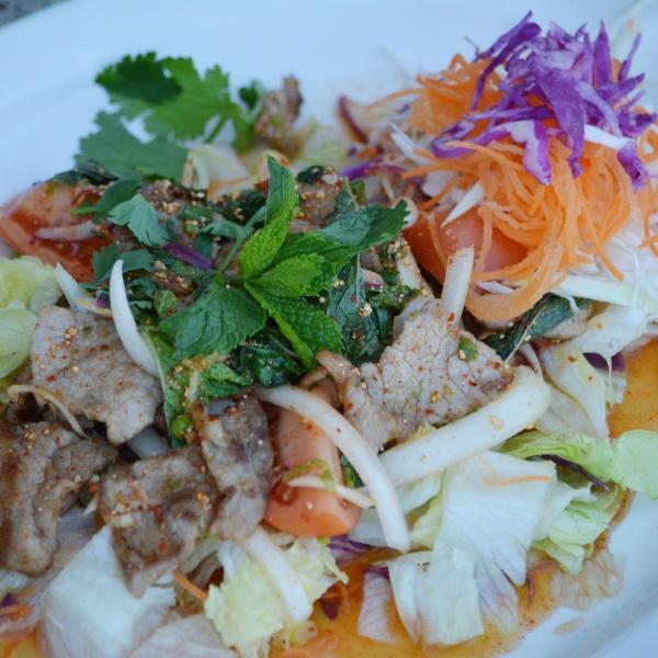 SL6. Spicy Beef Salad · Thinly sliced grilled beef tossed with Thai herbs, lime juice, fresh garlic, chili, onion and cilantro served over lettuce.