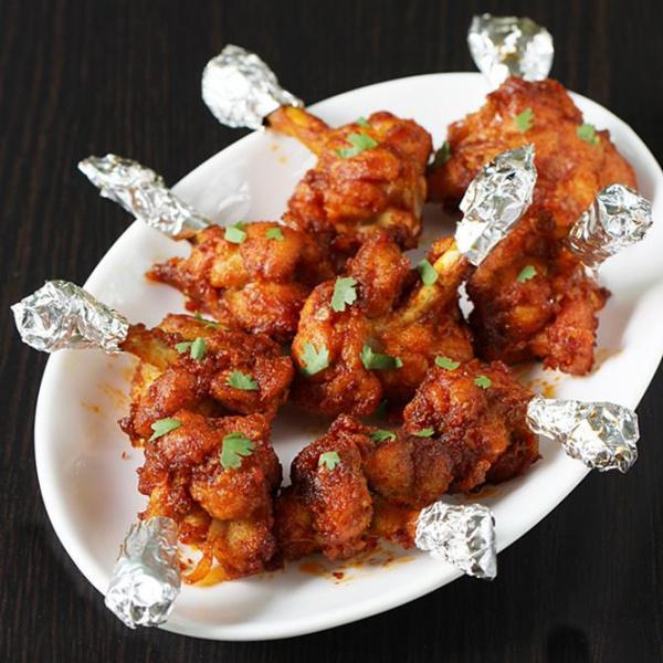 Chicken Lollipop · Chicken wings are pulled onto 1 end to form a lump of meat, hence called as lollipops. These are battered in a blend of spices and sauces and then deep fried for a juicy bite.