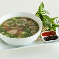 Beef Pho · Slices of raw rare steak and brisket. Served with rice noodle and chicken or beef broth topp...