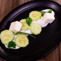 Yogurt and Cucumber · Homemade creamy yogurt with chopped cucumbers and flavored with diced mint.