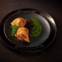 Vegetable Samosa · 2 pieces of seasoned potatoes and peas in a light pastry.