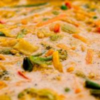 Navaratna Korma · Garden vegetables cooked in a cream based cashew onion sauce, lightly spiced. Served with ba...