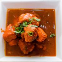 Chicken Vindaloo · Curried chicken cooked with fresh ginger, garlic and potatoes in a fiery sauce. Served with ...