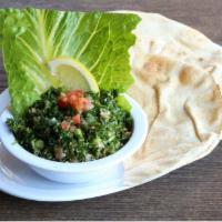 Tabbouleh · Cracked wheat, chopped parsley, tomatoes, green onions, olive oil and lemon juice.