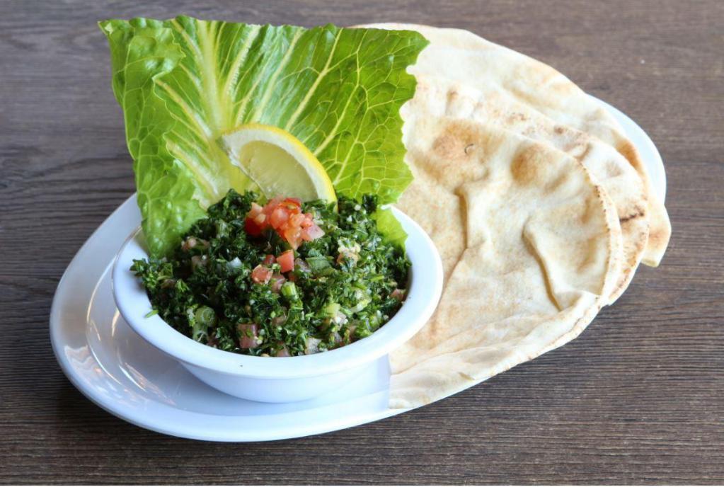 Tabbouleh · Cracked wheat, chopped parsley, tomatoes, green onions, olive oil and lemon juice.