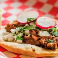 Barbacoa Taco · Barbacoa of beef. Served in a corn tortilla topped with onion, cilantro and radish, with spi...