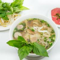 1. Large Combination Pho · Vietnamese pho noodle soup served with steak, well done brisket, beef ball, tendon, and trip...